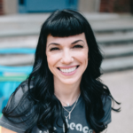 Smiling white woman with long black hair