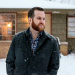 Smiling white man with red-brown hair and beard