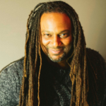 Smiling black man with long dreadlocks